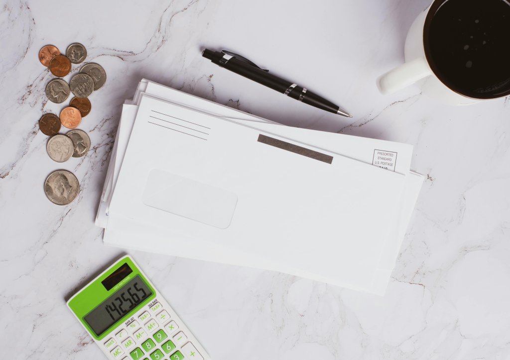 Photo by Jason Deines: https://www.pexels.com/photo/stacked-of-bills-and-coins-on-marble-surface-6110309/.